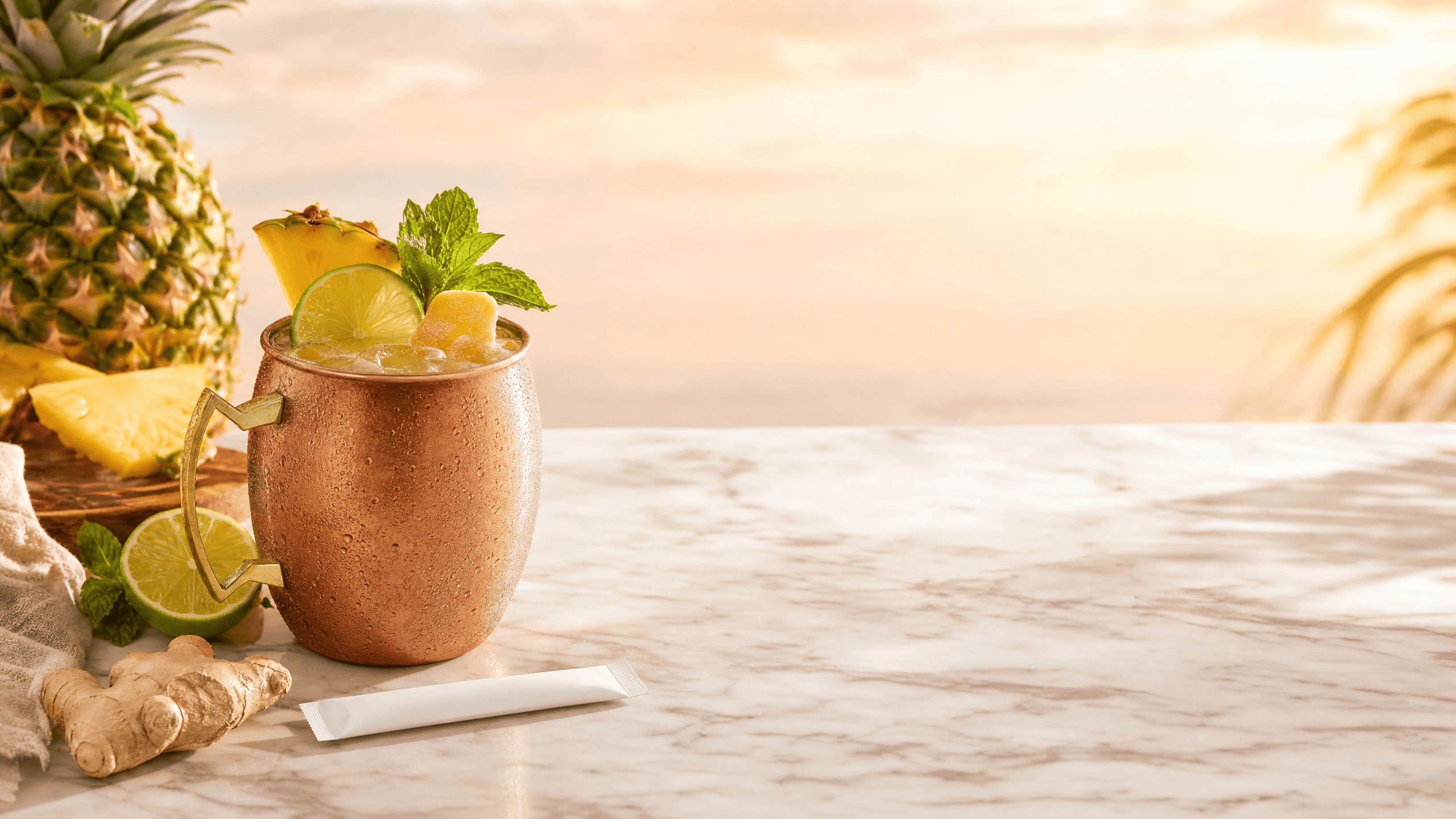 A pineapple kava mule in a copper-style mug with ginger beer, lime, pineapple, mint, and crushed ice